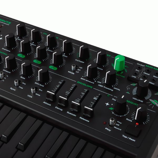 Close-up of a black synthesizer with control knobs and buttons on a white background
